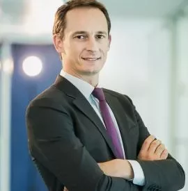 Man in a suit with arms crossed