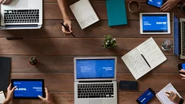 Top view of a team meeting with laptops