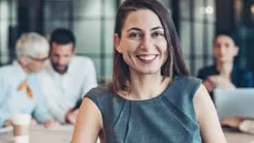 Smiling woman in a grey dress