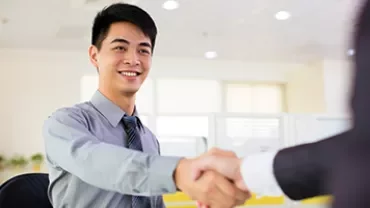 Smiling person in office shaking hands