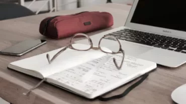 Open notebook with glasses