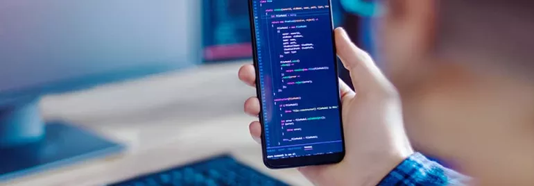 Person holding smartphone displaying code