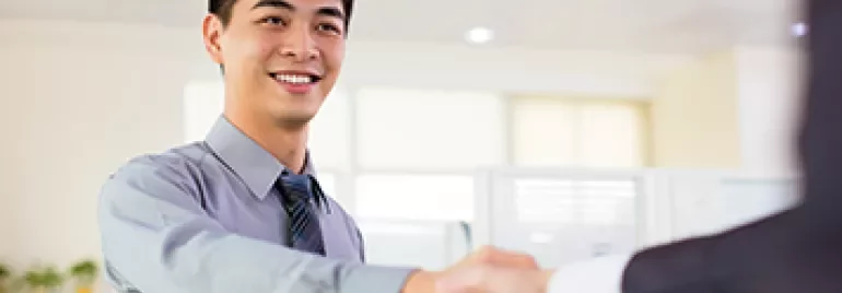 Smiling person in office shaking hands