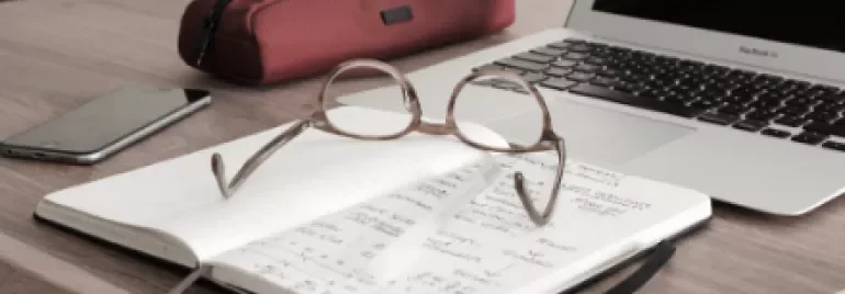 Open notebook with glasses