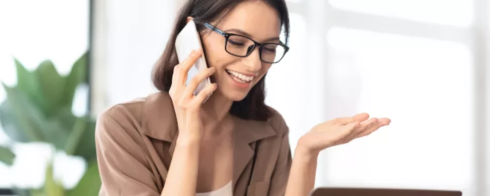 A woman talking on the phone | When to use a recruitment agency