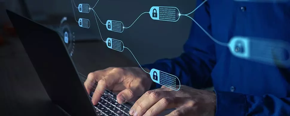 Person typing on laptop with digital blockchain links and padlocks in the foreground.