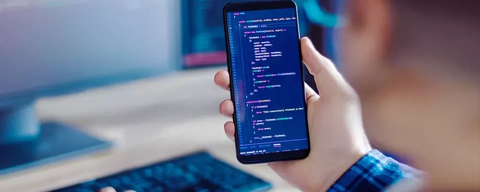 Person holding smartphone displaying code