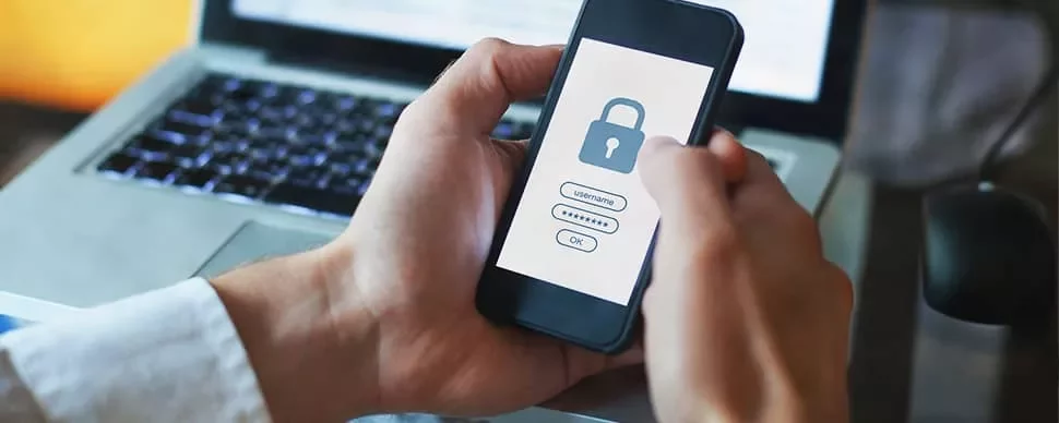 Person holding a phone with a lock screen for secure login.
