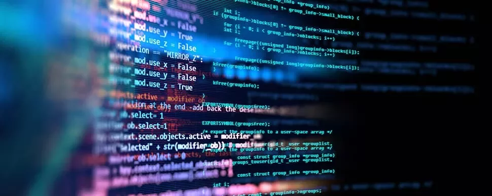 Close-up of computer code displayed on a screen with a colorful background.