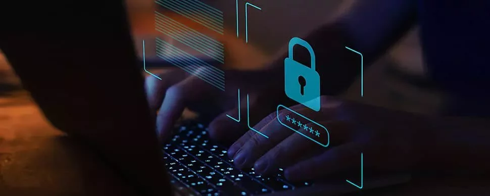 Hands typing on a laptop with a digital lock hologram