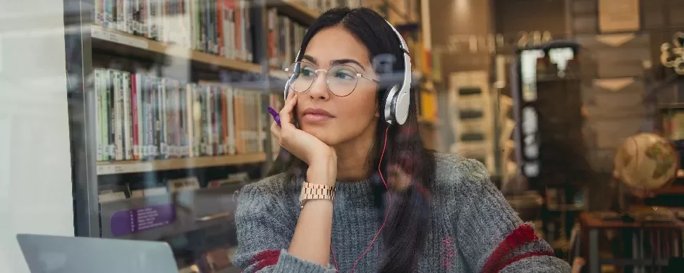 Woman wearing headphones and glasses