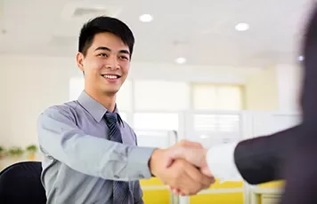 Smiling person in office shaking hands