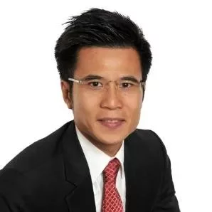 Portrait of a man in a suit and red tie with glasses against a white background.