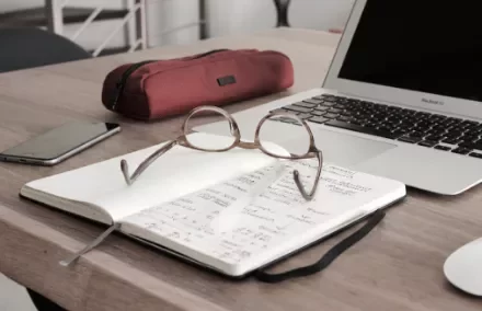 Open notebook with glasses
